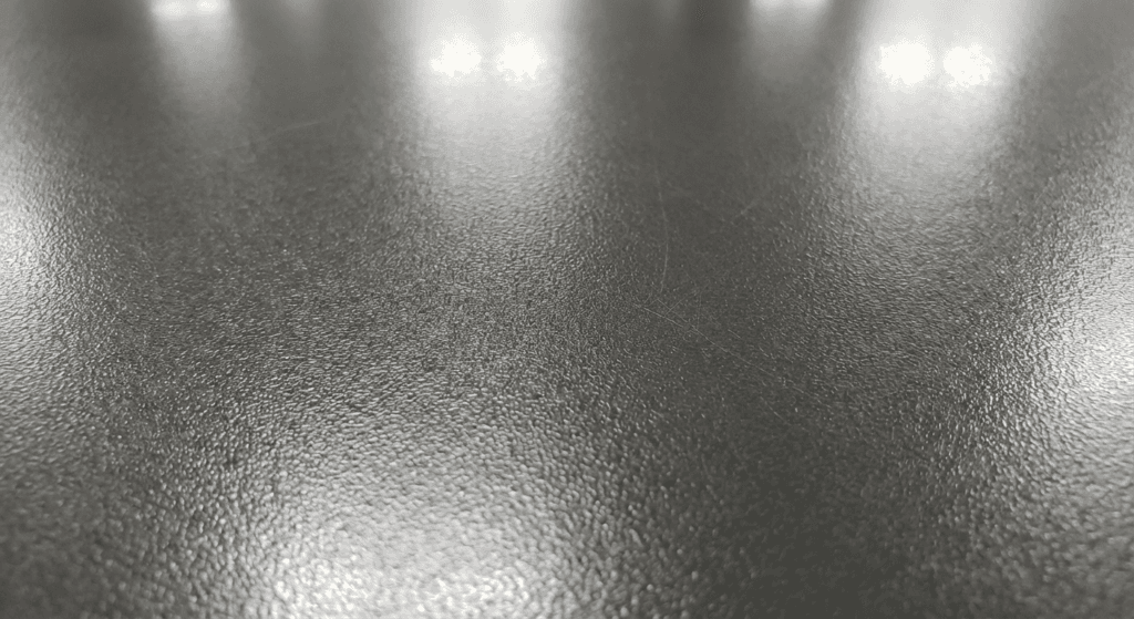 Extreme close-up of durable scratch-resistant commercial cabinet finish surface in Saskatoon, high-gloss reflective quality