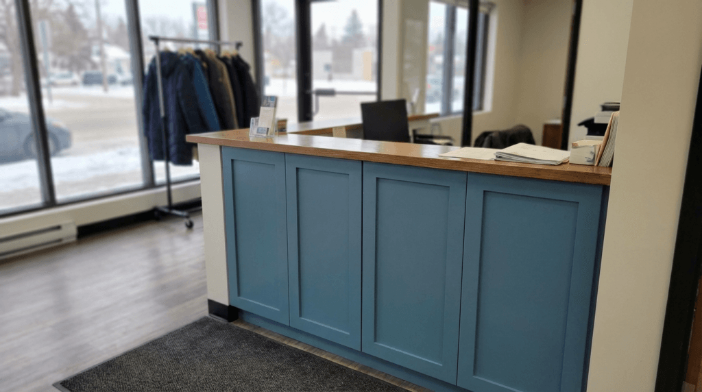 painted MDF cabinet doors with a smooth finish on a commercial reception desk in Saskatoon Saskatchewan
